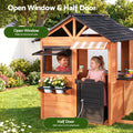 Wooden pretend kitchen playhouse for kids with cubby house design and side bench, ideal for outdoor pretend play and imaginative fun.