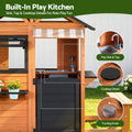Wooden pretend kitchen and cubby house outdoor playset for kids, featuring a side bench for imaginative play, by Everything Baby.