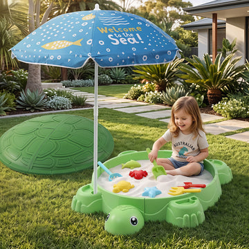 Green Keezi turtle sandbox toy with umbrella lid, includes 8 accessories for kids aged 3+ in a colorful activity toy setting.