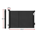 Black Keezi retractable baby and pet safety gate extended to 400cm, shown in a home doorway setting.