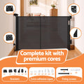 Black Keezi retractable baby and pet safety gate extending up to 400cm, shown in a home doorway setup.