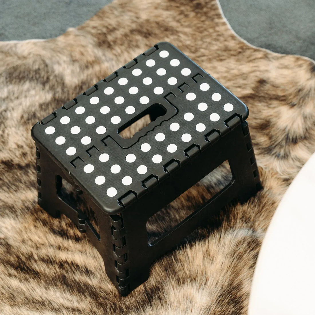 Black portable foldable plastic stool for kids and adults, suitable for outdoor, bathroom, and kitchen use with Everything Baby branding.