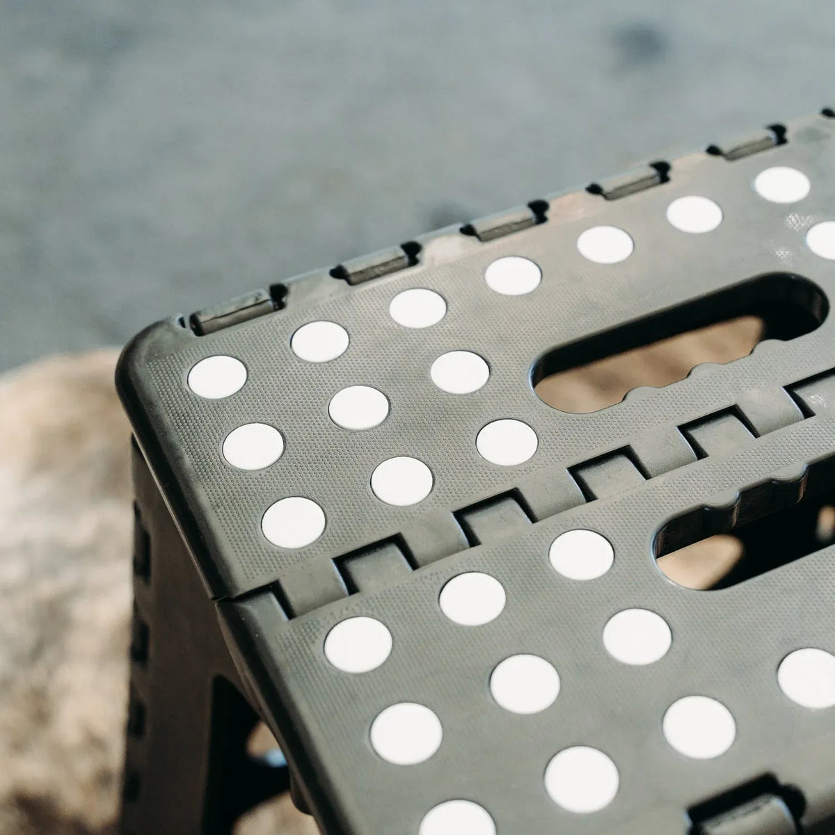 Black portable plastic foldable stool from Everything Baby, suitable for outdoor, bathroom, kitchen, and kids' seating.