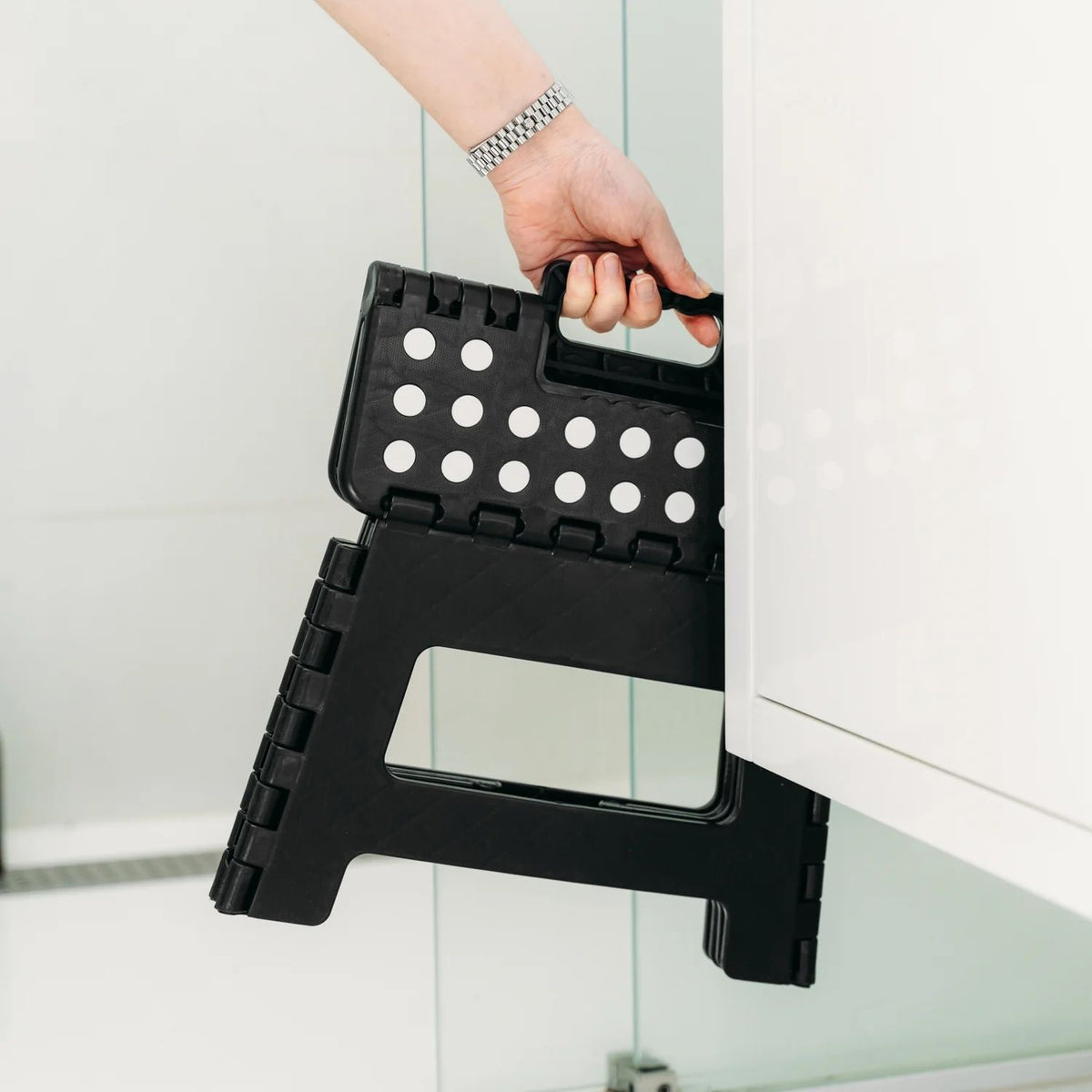 Black portable plastic foldable stool for kids and adults, suitable for outdoor, bathroom, kitchen, and kid's furniture use.