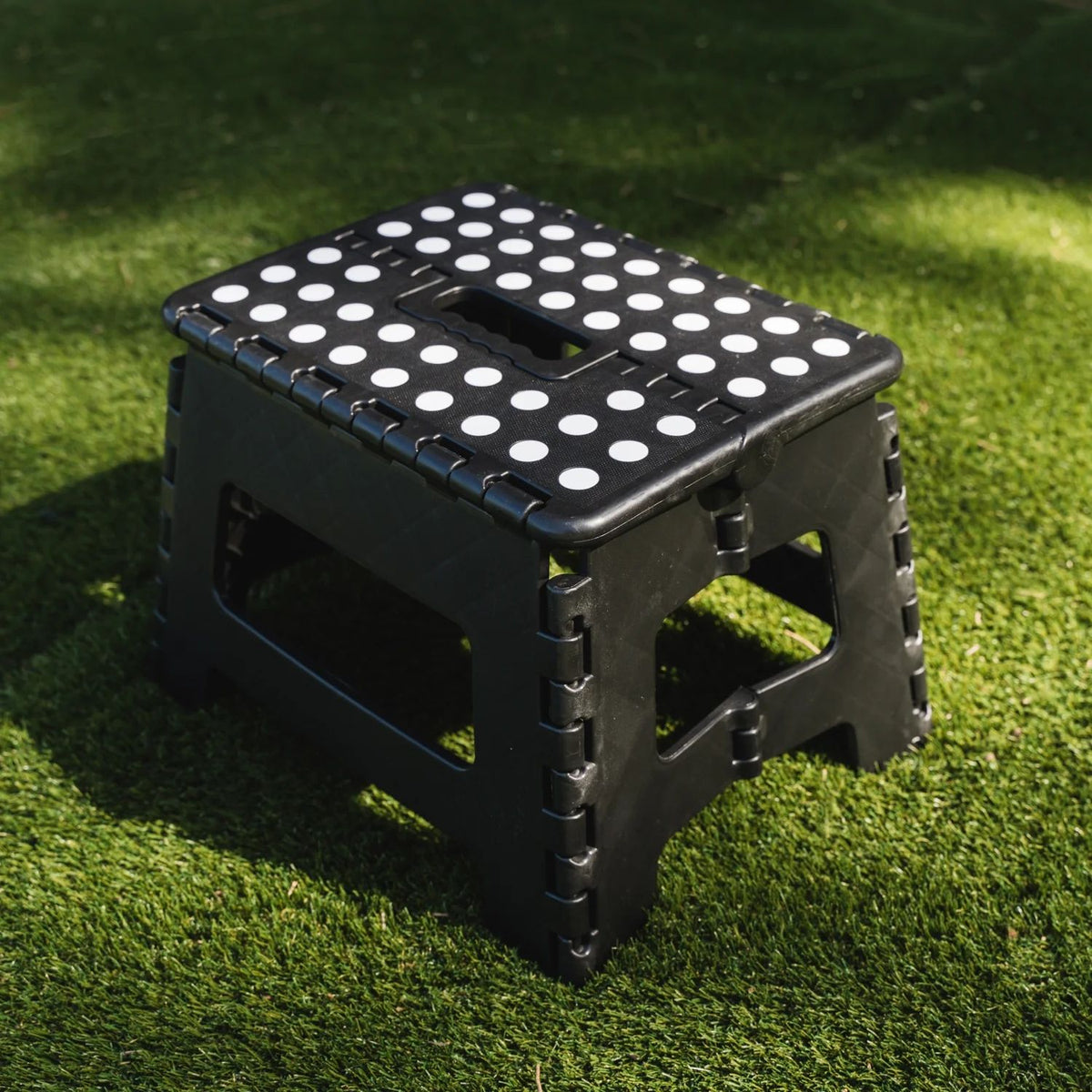 Black portable plastic foldable stool suitable for outdoor, bathroom, kitchen, adults, and kids, featuring a compact, lightweight design.