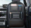Black car seat organizer for children with multiple pockets and iPad holder, designed for backseat storage and kid’s safety.