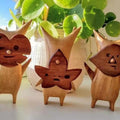 Three anime-style wooden resin statues of family and game characters, perfect for kids' room or gaming decor.