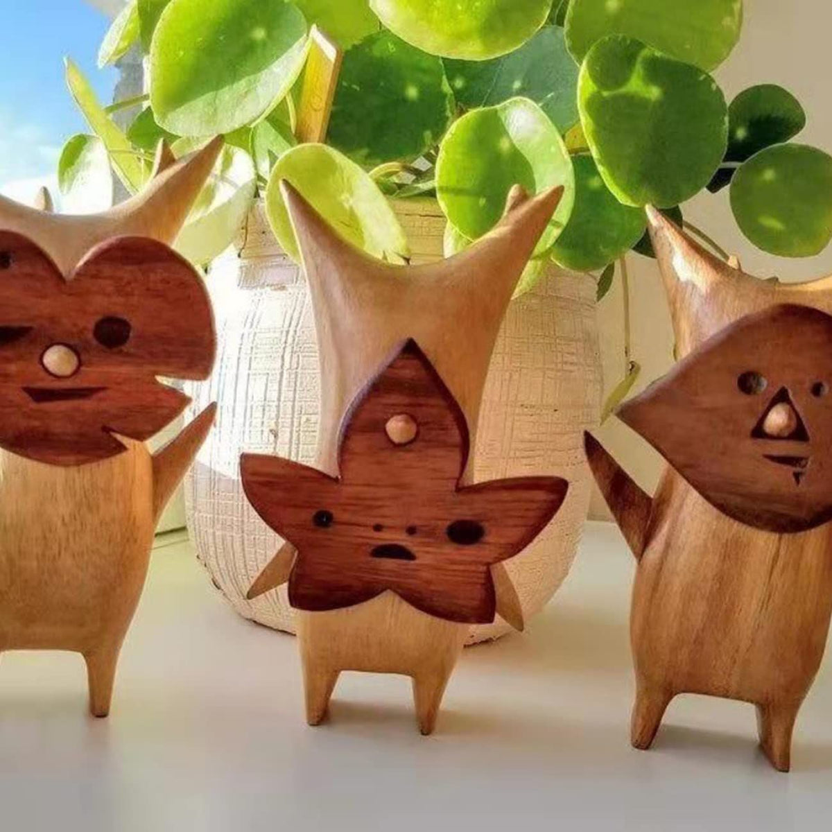Three anime-style wooden resin statues of family and game characters, perfect for kids' room or gaming decor.