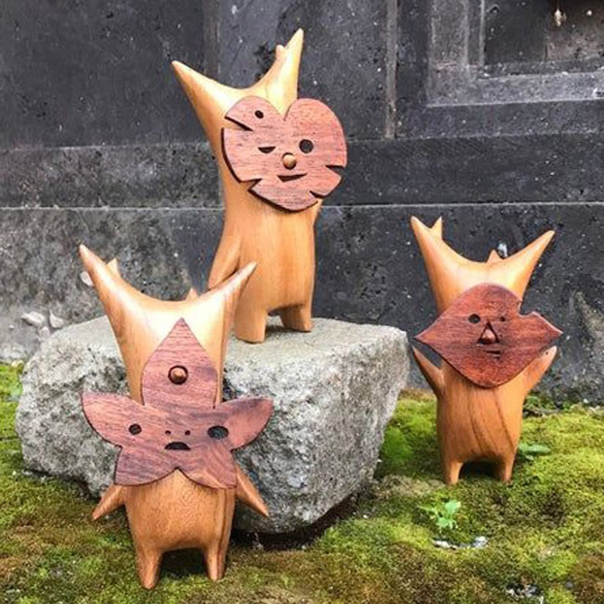 Three anime-style wooden resin statues of family and game characters, ideal for kids' or gaming room decor, by Everything Baby.