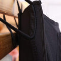 Black bedside hanging storage bag with eight pockets, suitable for bunk beds and hospital bed rails, from Everything Baby.