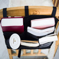 Black bedside hanging storage bag with 8 pockets for bunk beds and hospital rails, ideal for organizing baby and kids accessories.