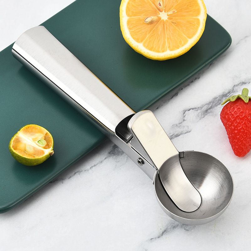 Heavy-duty stainless steel ice cream scoop with trigger for easy serving, suitable for fruit and dessert portions.