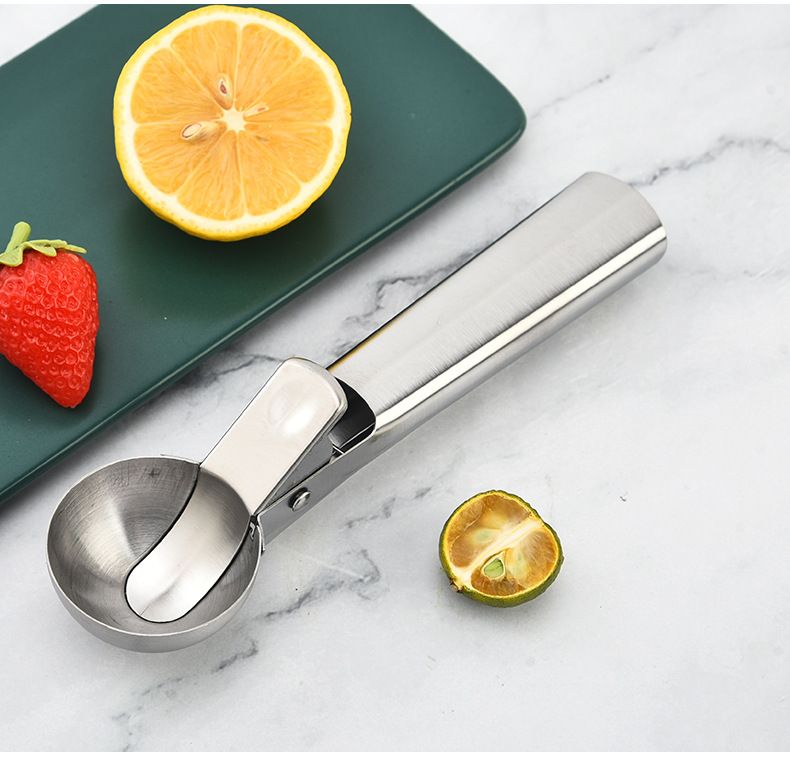 Heavy-duty stainless steel ice cream scoop with trigger, ideal for fruit and ice cream servings, designed by Everything Baby.