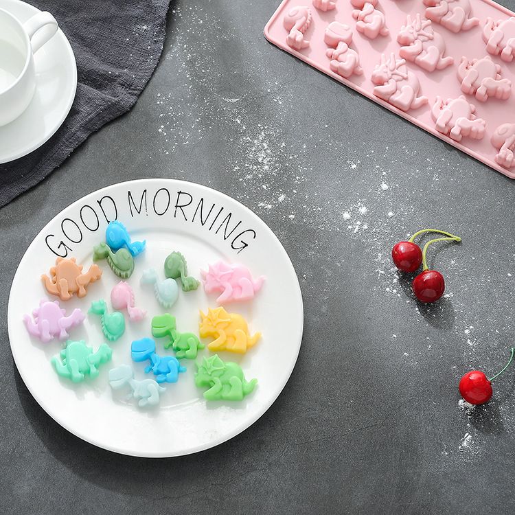 Silicone mold by Everything Baby with dinosaur and animal shapes for baking or pretend play, food-grade non-stick material.