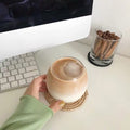 Handmade natural rattan coaster with woven design, ideal for drinks, featuring rustic boho farmhouse style.