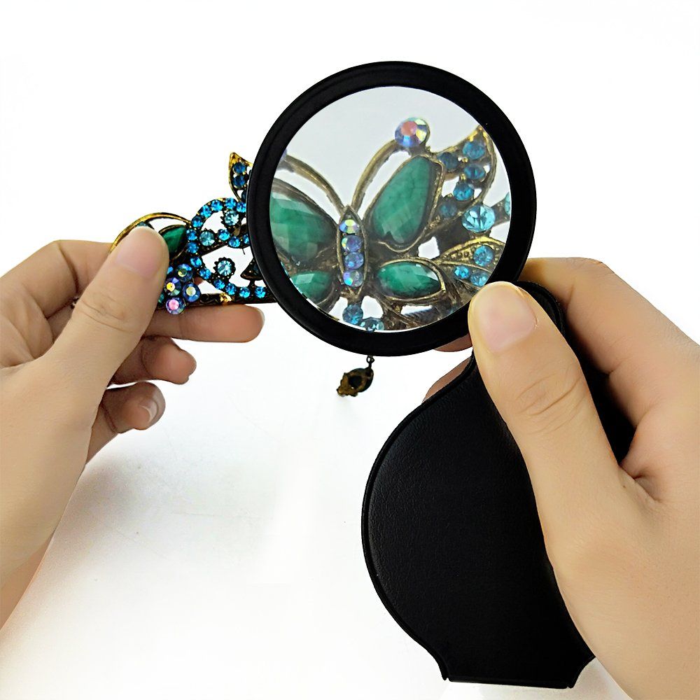 Black folding pocket magnifier loupe with rotating leather holster, 70mm size, ideal for reading, science, and hobbies.
