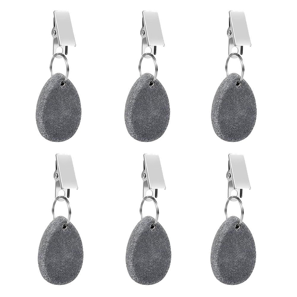 Six teardrop-shaped tablecloth weight pendants with metal clips from Everything Baby, used to secure table covers during family meals.