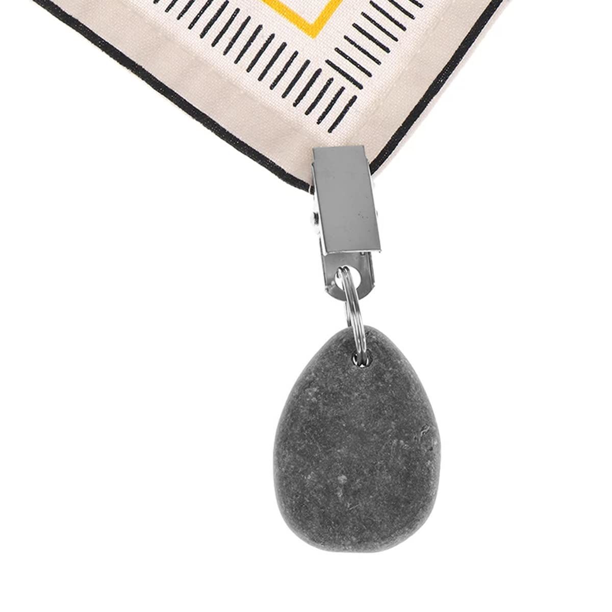 Six teardrop-shaped tablecloth weights with metal clips, designed for secure fabric coverage, in a neutral stone color by Everything Baby.