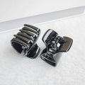 Three black jaw clips for thick hair, non-slip mini oval hair claws ideal for women and girls, from Everything Baby.