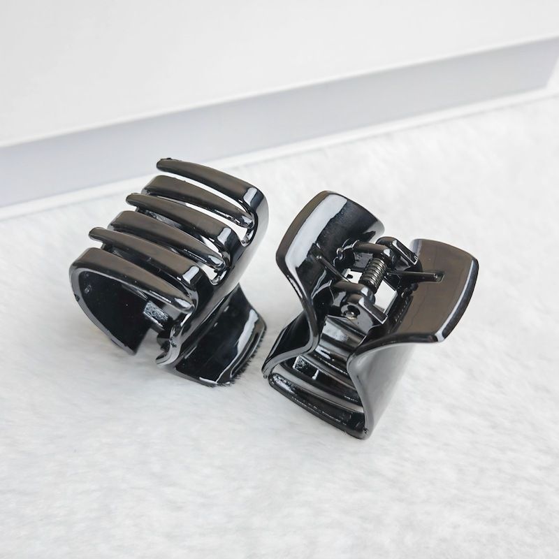 Three black jaw clips for thick hair, non-slip mini oval hair claws ideal for women and girls, from Everything Baby.