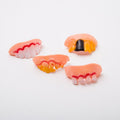 Set of 10 Halloween vampire fangs teeth for kids, plastic vampire dentures for costume parties and spooky decorations.
