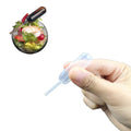 Set of 50 plastic cupcake pipettes with 4 ml squeeze droppers, ideal for decorating strawberries, cupcakes, and chocolates.