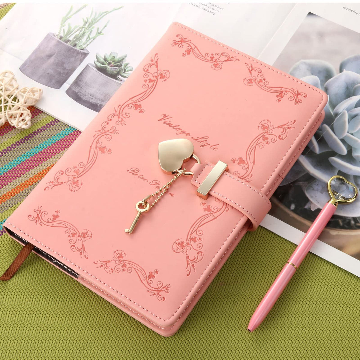 Pink girls' diary with heart-shaped lock and key, refillable leather journal for teens, featuring cute design and toy-like appearance.