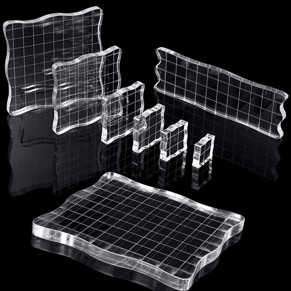 Seven clear acrylic stamp blocks with grid and grip, ideal for kids' scrapbooking and decorative stamping projects.