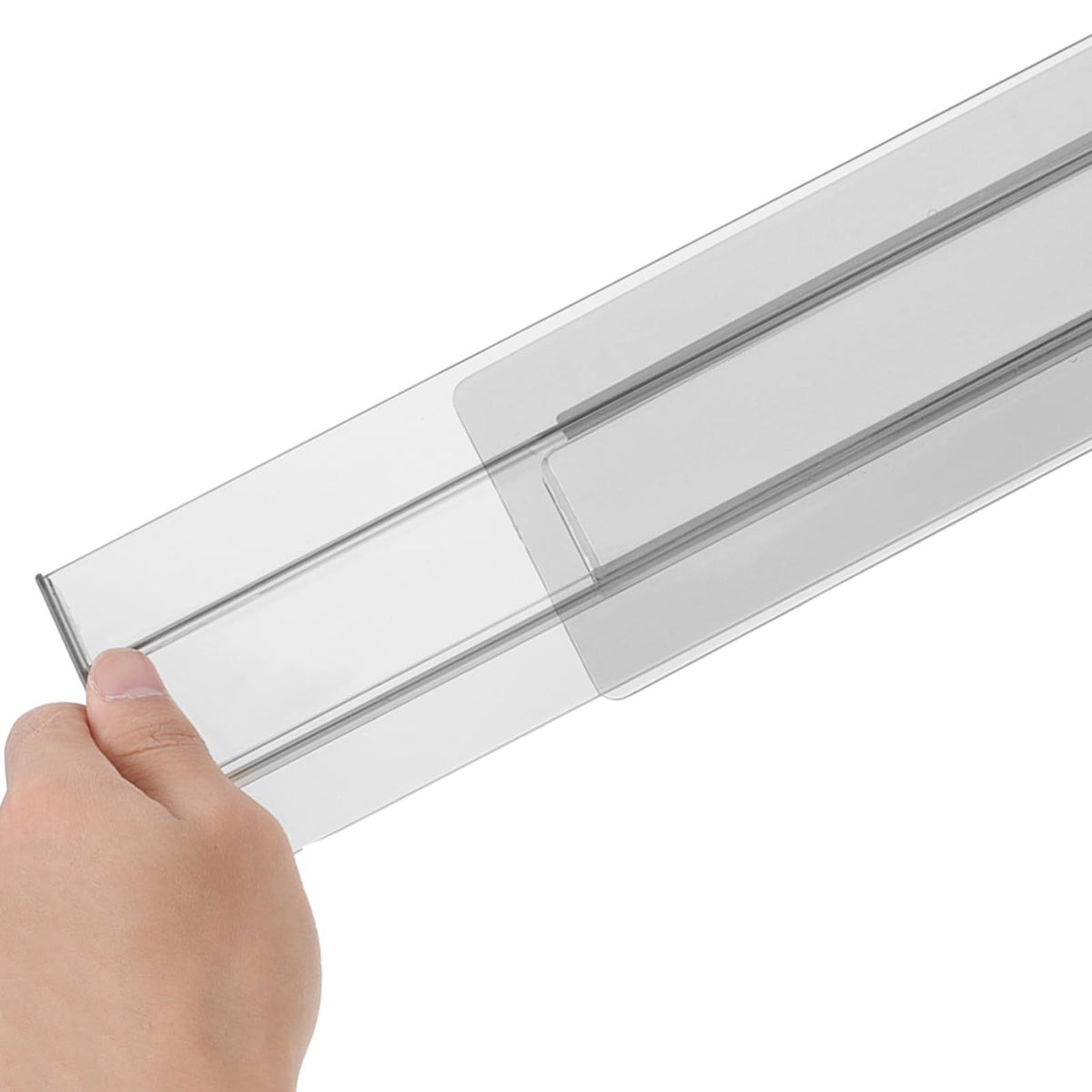 Adjustable transparent plastic drawer partition in a baby's changing table, flexible extendable organizer for kid's furniture.