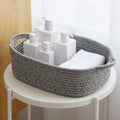 Woven cotton rope storage basket by Everything Baby holding nursery towels and toys, cube-shaped for kids' and baby room organization.