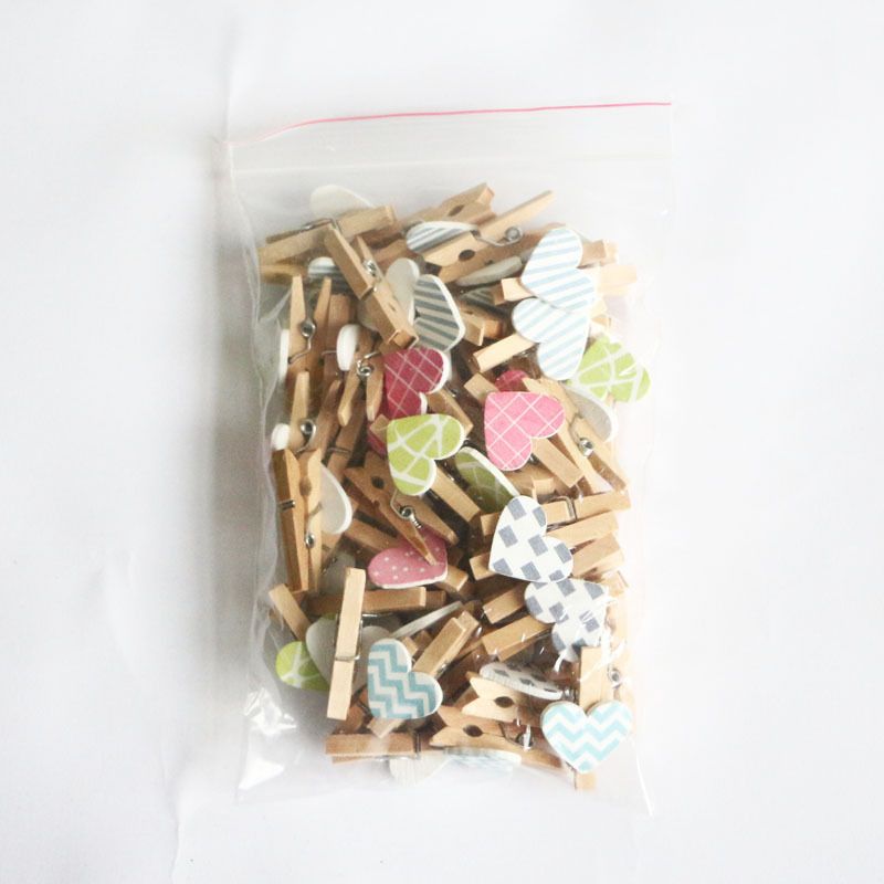 Set of 50 mini wooden heart-shaped clips for photo holding and crafts, ideal for kids' building toys and creative projects.