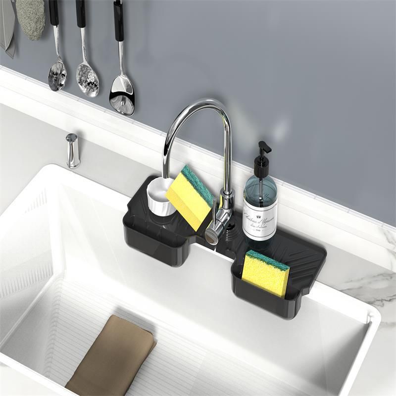 Two silicone faucet splash guard mats with dish sponge holder, used to catch water and protect sink surfaces, in a baby and kids' nursing area.
