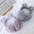 Pair of fluffy plush foldable winter ear muffs for women and kids, warm ear warmers for cold weather by Everything Baby.