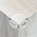 Set of 12 clear ball-shaped corner guards for baby furniture, edge protectors to prevent injuries on tables and sharp corners.
