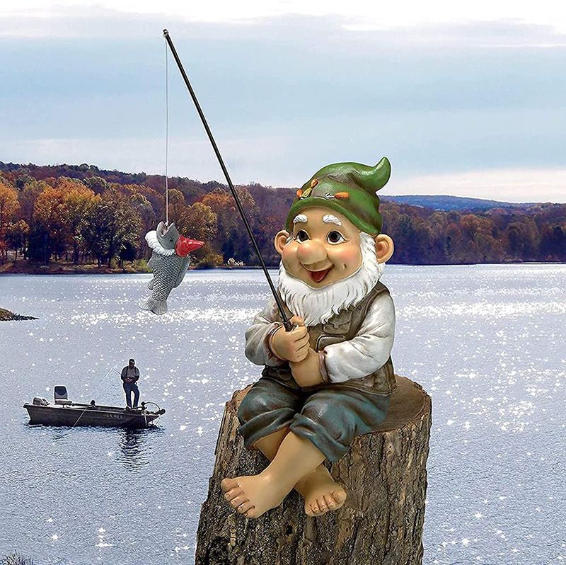 Outdoor garden fishing gnome statue by Everything Baby, seated with a fishing rod, perfect for garden decoration.