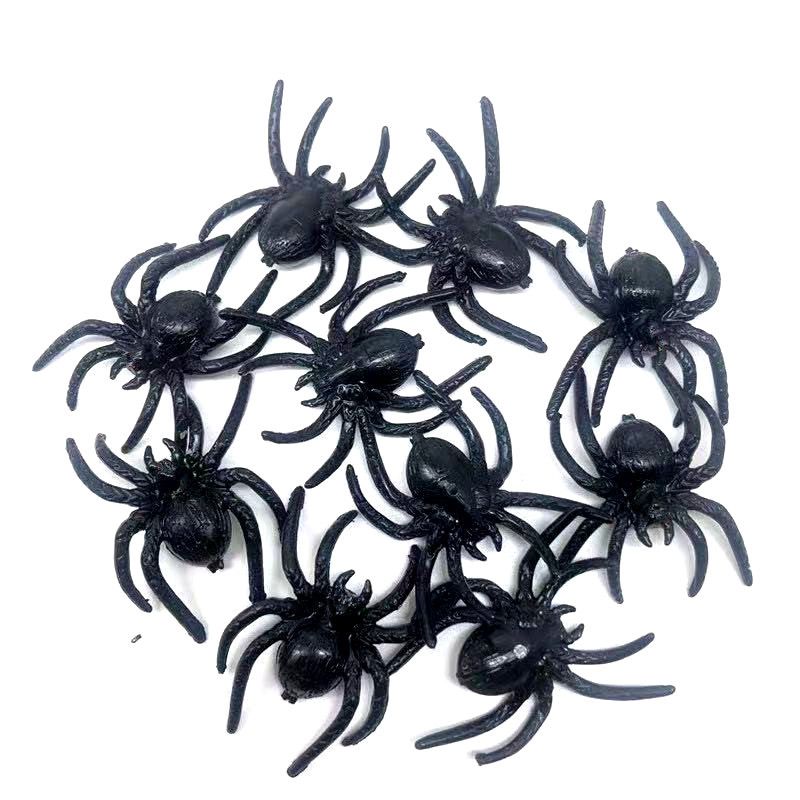 Set of 10 realistic black plastic fake spiders for Halloween decoration and pretend play in kids' toy and spooky prop collection