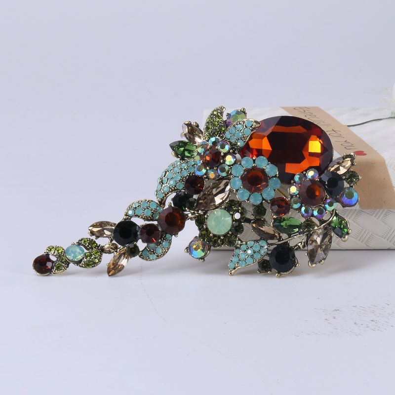 Fashion brooch pin featuring a fish drip oil design with crystal glass accents, suitable for women's shirts and floral outfits.