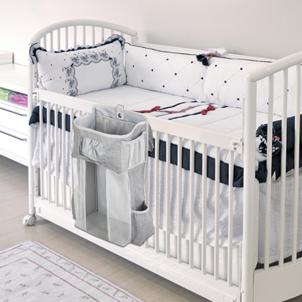 Everything Baby hanging diaper organizer with multiple compartments for baby diapers and essentials on a nursery crib.
