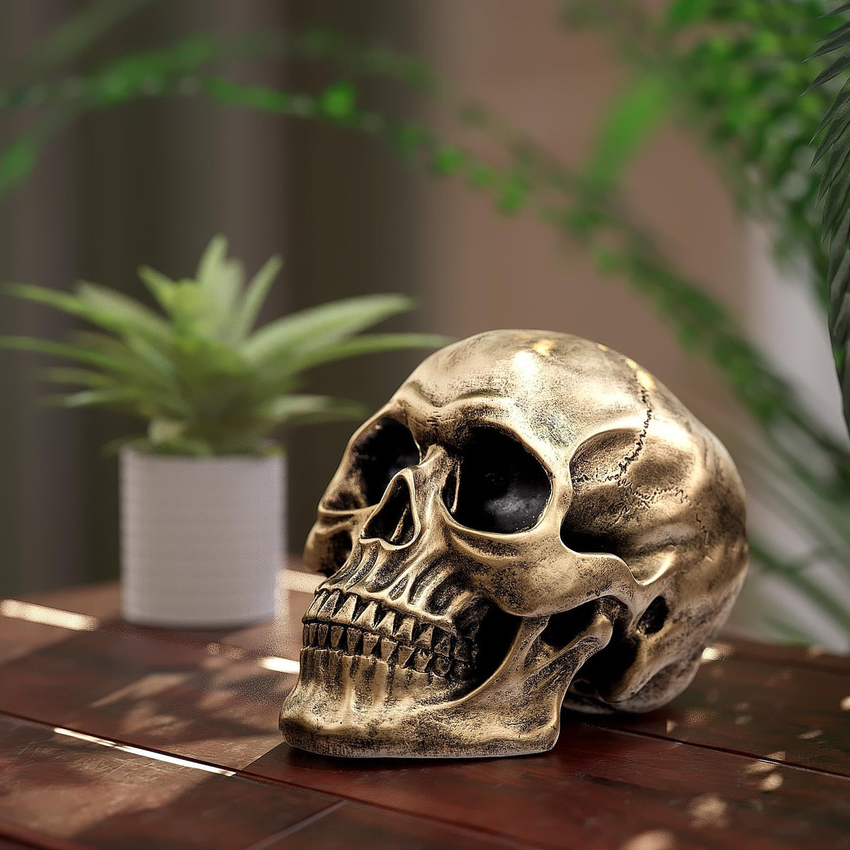 Gold life-size human skull model replica, realistic adult skull head bone for Halloween or party decorations.
