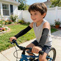Four pairs of black and white kids' arm sleeves from Everything Baby, reusable sun protection and cooling compression sleeves for boys and girls.