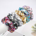 Six large gold metallic lame leaf hair scrunchies for girls, shiny ponytail holders for dance, gym, or party looks.