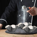 Black petal-shaped carbon steel baking bowl and tortilla pan set, non-stick taco shell maker for kids' pretend play activities.
