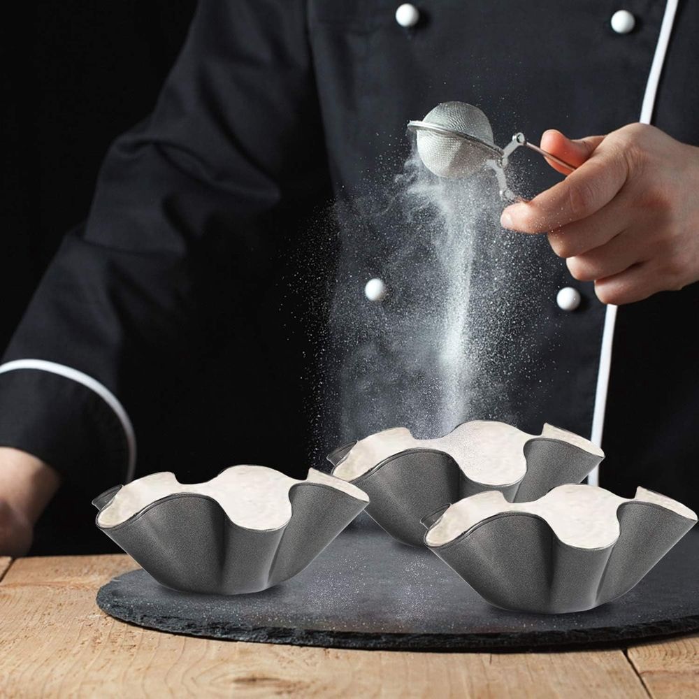 Black petal-shaped carbon steel baking bowl and tortilla pan set, non-stick taco shell maker for kids' pretend play activities.