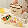 Stainless steel double layer lunch box with multiple compartments, microwave safe, ideal for kids' school meals and outdoor use.