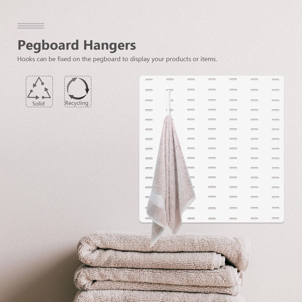White plastic hangers from Everything Baby, set of 7, easy to install, ideal for organizing children's clothing and toys.