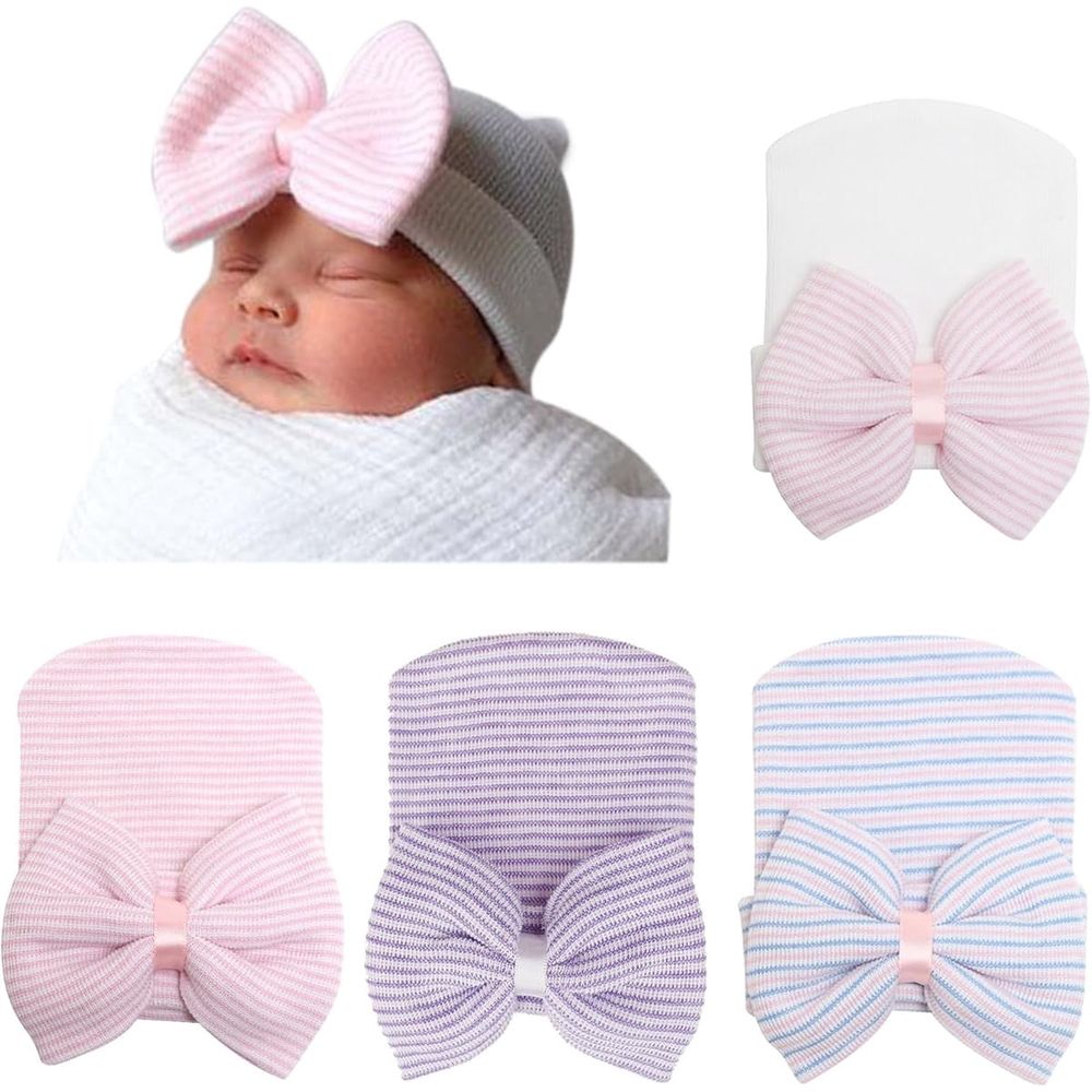 Set of four soft newborn baby girl caps with bows, infant hospital hats from Everything Baby, perfect for newborns and babies.