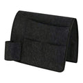 Dark gray bedside caddy organizer with four pockets hanging on a bed for dorm or home, made of durable fabric for easy storage.