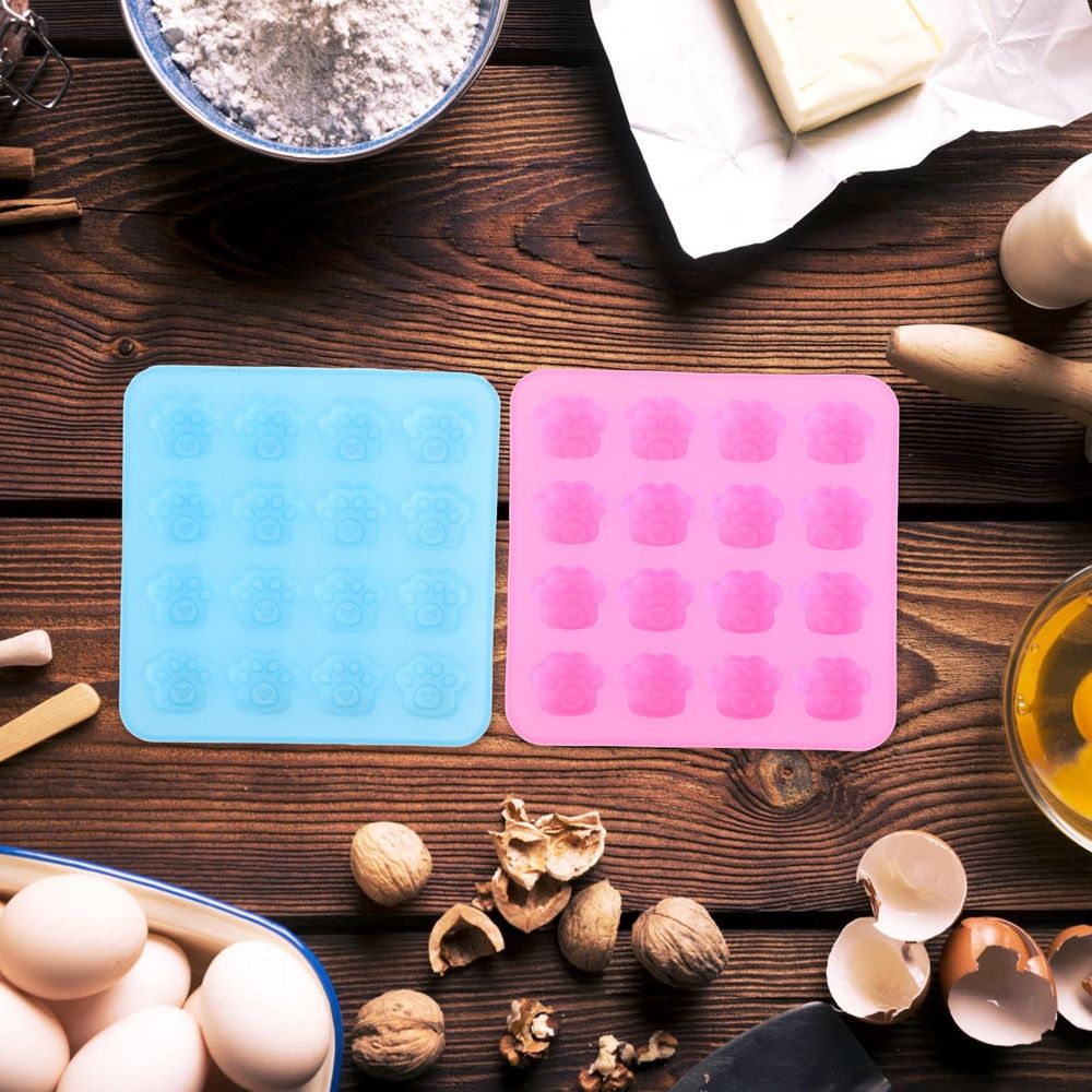 Two paw-shaped silicone molds for candy, chocolate, and dessert baking, ideal for home use, by Everything Baby.