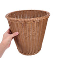 Woven plastic waste basket with large capacity for household use, suitable for storing toys or paper waste in a kid's room.