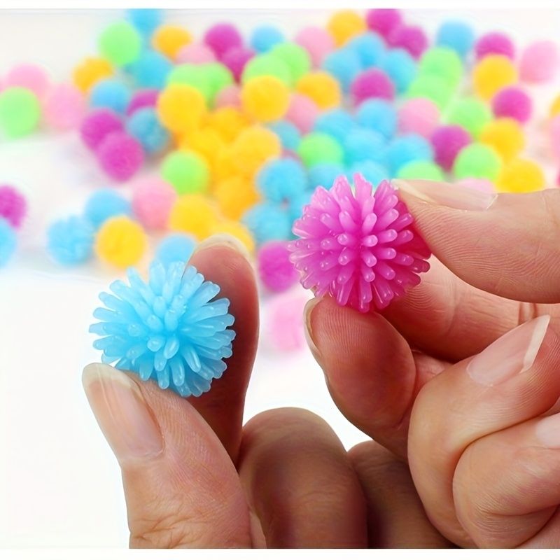 Set of 15 colorful baby massage balls with hedgehog design, ideal for foot and body relaxation and play in a ball pit.